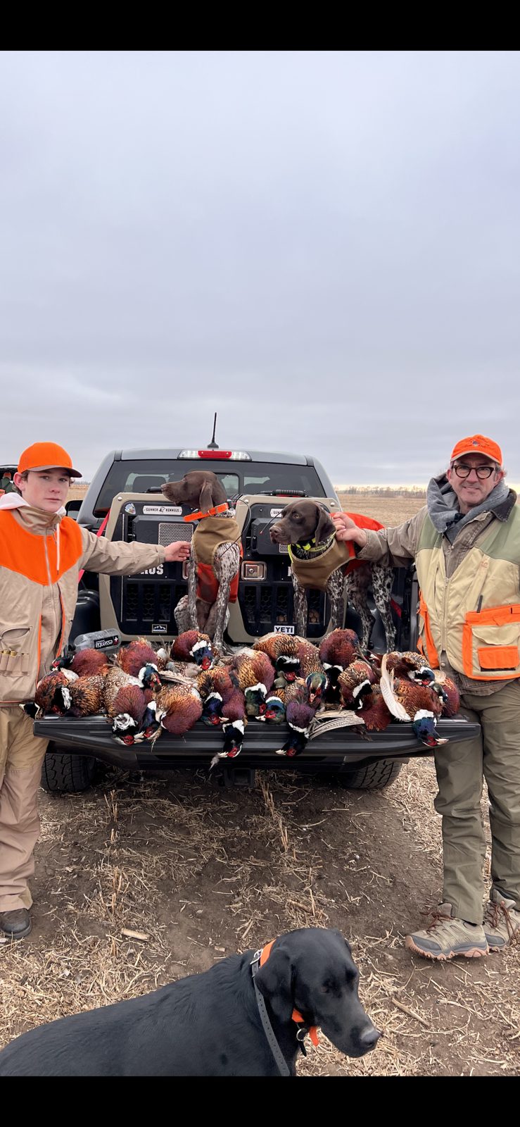 Karl and Brus on the truck with hunters and a limit of roosters